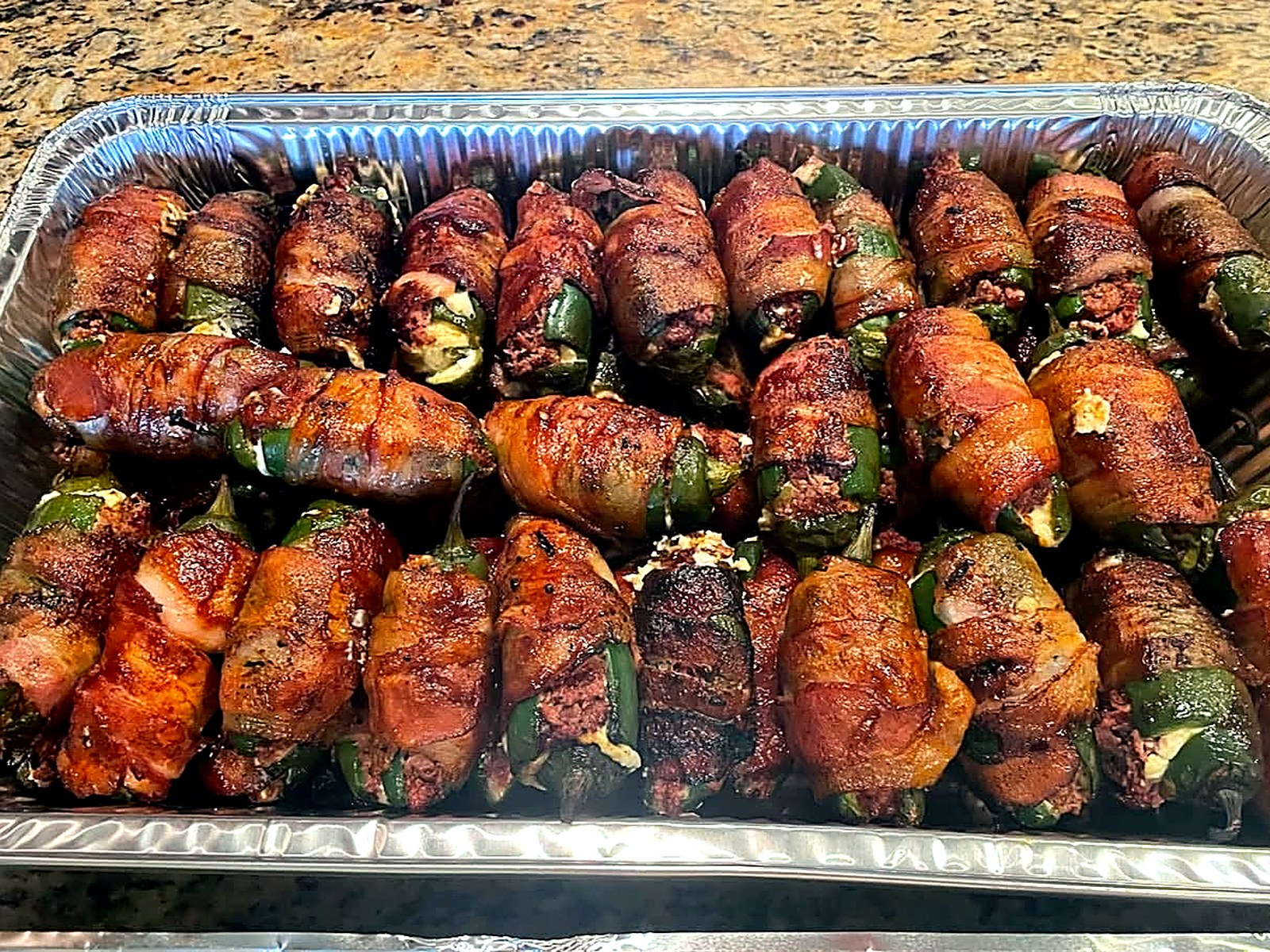 Texas Twinkies: smoked, bacon-wrapped jalapeño poppers on a catering tray.